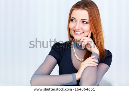 Portrait of a beautiful cheerful woman looking right at copyspace