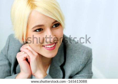 Closeup portrait of a cheerful businesswoman isolated on a white background