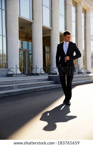 Confident businessman walking on the street