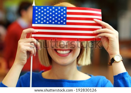 Portrait of a cheerful student with flag of USA