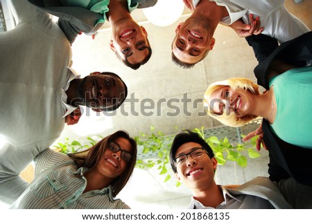 Smiling business people with their heads together representing concept of ftiendship and teamwork