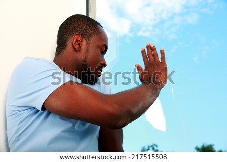 Portrait of african man looking at window