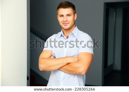 Portrait of a handsome man with arms folded