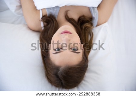 Top view portrait of a beautiful cute woman on the bed