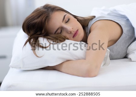 Portrait of a woman sleeping on the bed at home