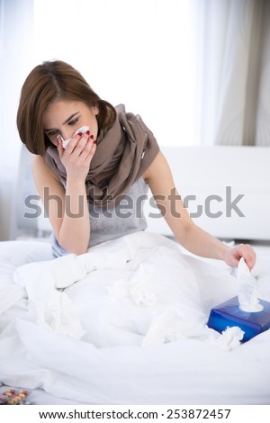 Sick Woman. flu. woman caught cold. sneezing into tissue