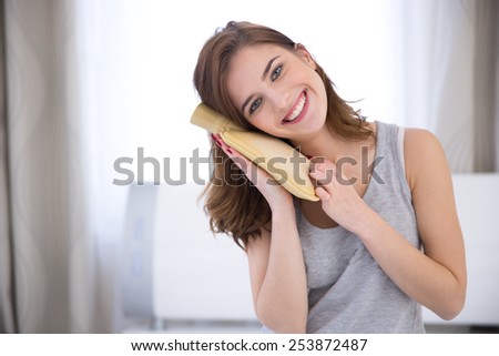Portrait of a smiling young woman with a hot water bottle