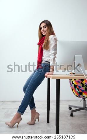 Portrait of a beautiful smiling woman leaning on the table