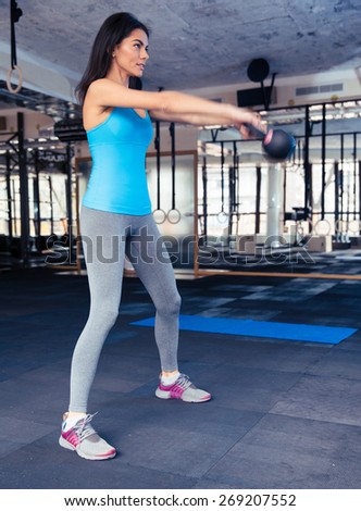 Full length portrait of a young woman attractive young working out at gym