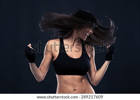 Portrait of a woman dancing with hair in motion over black background