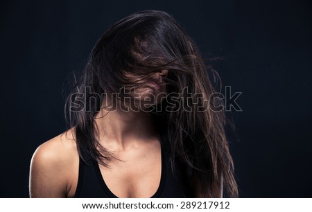 Portrait of exhausted woman over black background