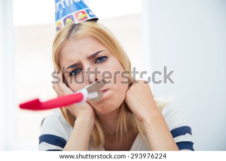 Beautiful woman with party hat and blows whistle