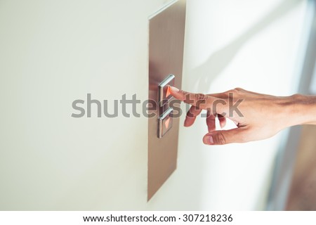 Closeup portrait of a female finger pushing elevator button