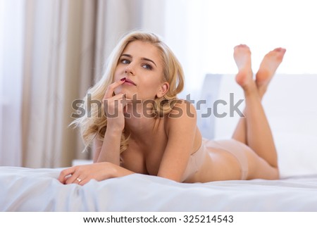 Portrait of a sexy cute woman in lingerie lying in the bed