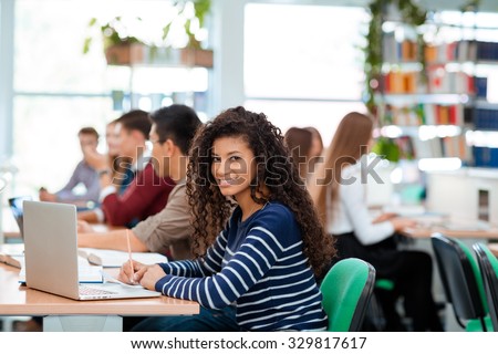 Portrait of a students studying in university library