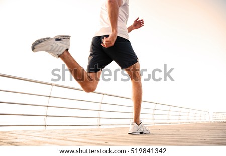 Blurred cropped image of athlete runner in motion