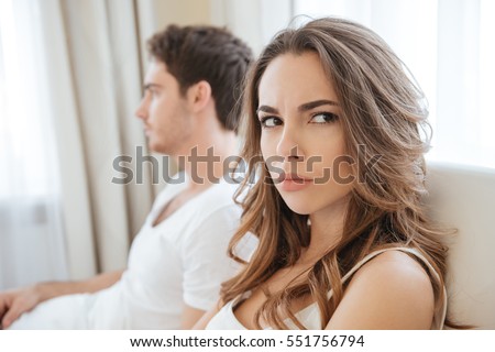 Sad unhappy young couple having problems in bed