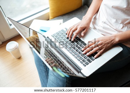 Top view of African Woman sitting near the window with laptop in library