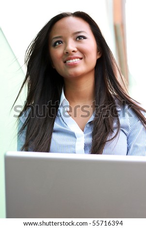 Woman on laptop outside in the city