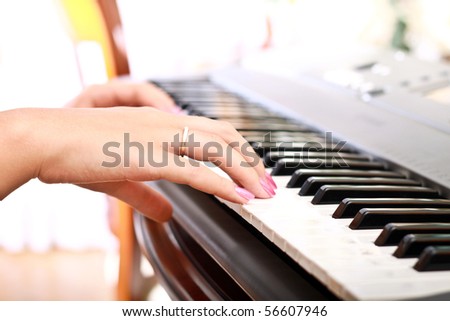 woman playing on electric piano