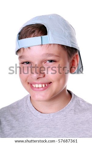 Isolated portrait of a young boy in cap smiling