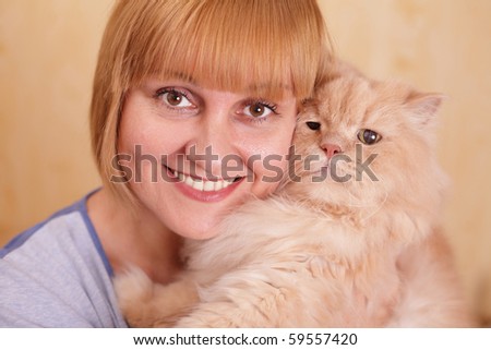 Happy smiling woman with her fluffy cute pet at home