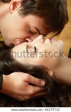 Young man kisses his beautiful girlfriend