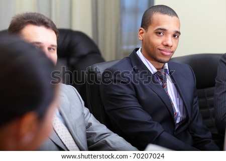 Multi ethnic business team at a meeting. Focus on african-american young man