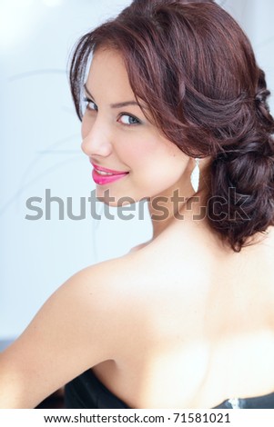 Closeup portrait of a beautiful seductive young woman looking back