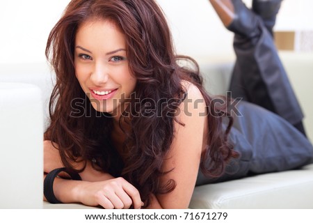 Portrait of a charming young lady relaxing on couch