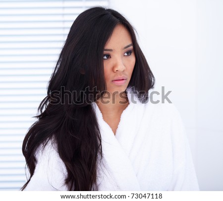 Portrait of a gorgeous asian woman in white bath robe