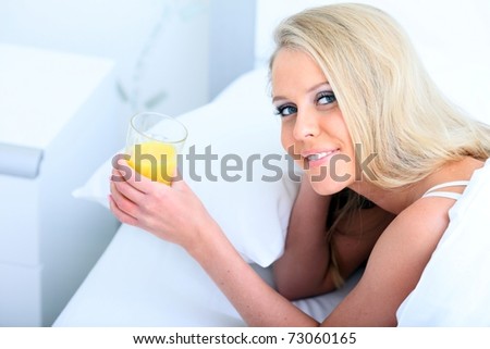 Young beautiful woman with juice in the morning