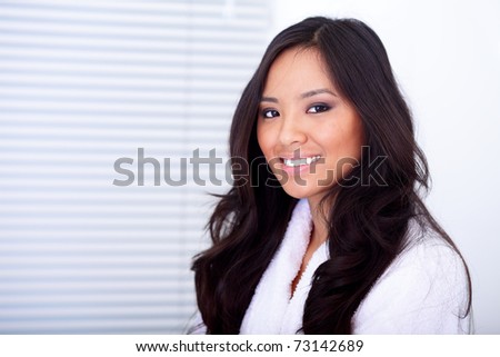 Happy healthy asian woman in white bath robe
