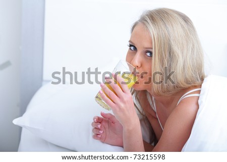 Young beautiful woman with juice in the morning