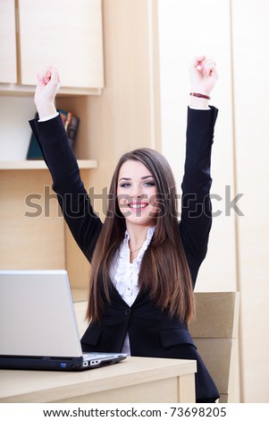 Happy young businesswoman happy because of good news from laptop