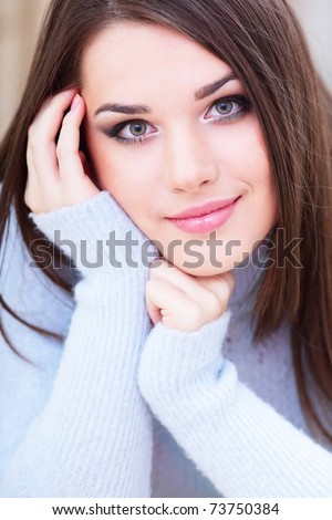 Portrait of a young cute woman in warm sweater
