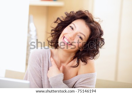 Beautiful happy woman indoors laughing