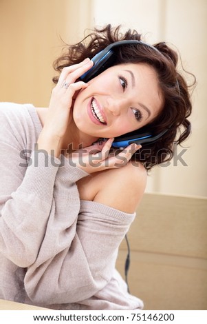 happy cute young lady listening to music on a headset