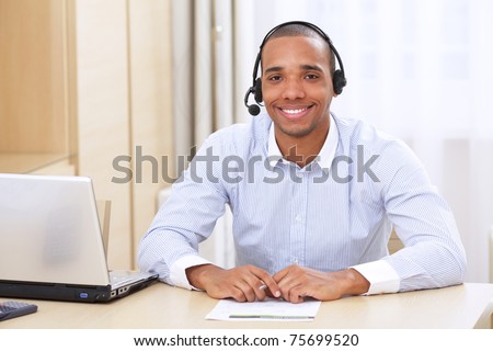 young african american call center consultant with headset in office