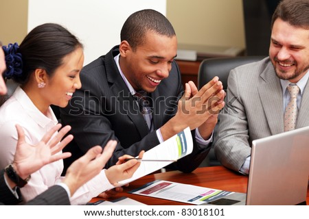 Multi ethnic business team at a meeting. Interacting. Focus on african-american man