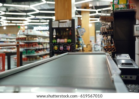 Cropped picture of cashier's desk in supermarket shop