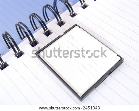 Page of a notebook with compactflash for storage of the information on the camera.  COPYSPACE - a place for accommodation of advertising in a photo.