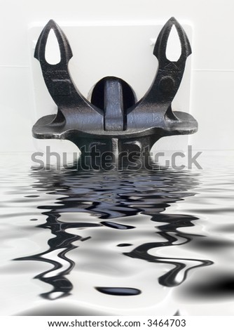 Heavy metal anchor on board the ship in port. Reflection in water