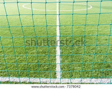 Field for game in football with a green grass and white lines a kind through a grid