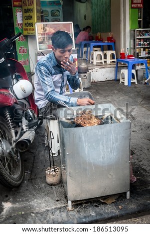 HANOI, VIETNAM, JANUARY 27: Vietnamese man cooking on the street. A common sight in the countries capital city Hanoi. In January 27, 2014.
