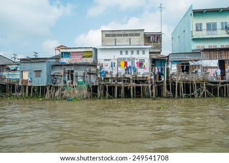 CAN THO, VIETNAM - JANUARY 26: Run down houses on the bank of Mekong river on January 26, 2014 in Can Tho, Vietnam.