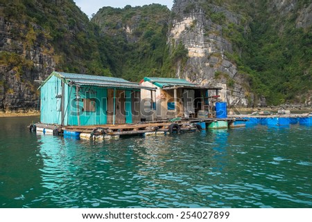 HA-LONG BAY, VIETNAM - JANUARY 28: Run down houses in a floating village on January 28, 2014 in Ha-long Bay, Vietnam.