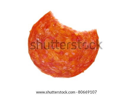 Single slice of salami with a missing bite over white