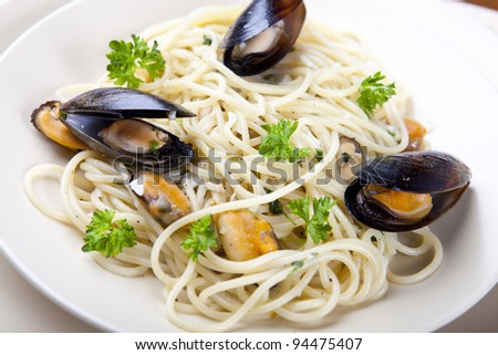 Spaghetti with Clam Sauce and Green Parsley on a Plate
