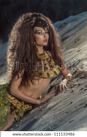 Oriental woman in ethnic costume in desert